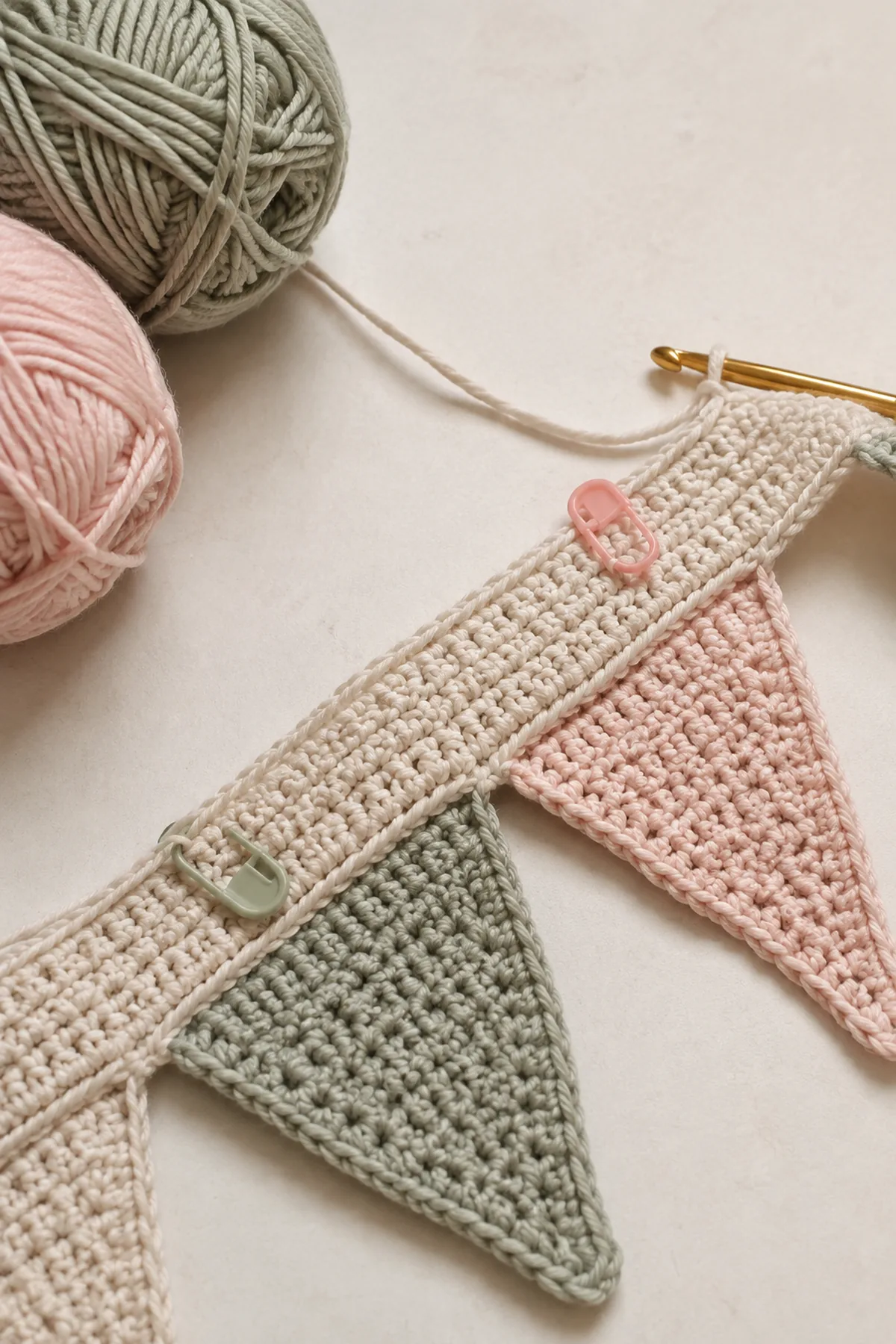 Early counted crochet stage of modern crochet nursery bunting with matching yarn and hook