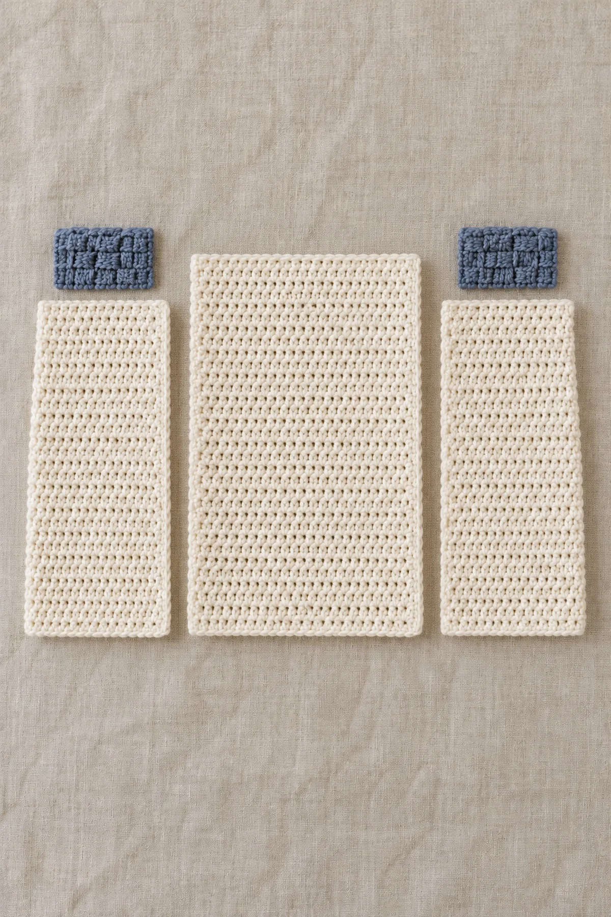 Separate ivory crochet back and two front rectangles beside two narrow slate basketweave shoulder strips, before shoulder assembly