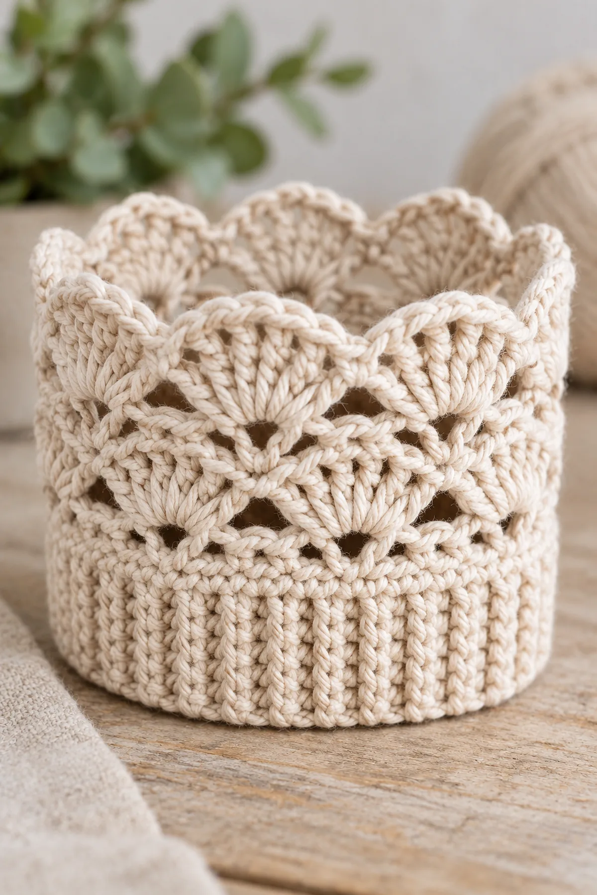 Macro of finished oat crochet boot cuff airy three-round fan lace above ribbed band, paired little scallop fans over open chain arches, soft cotton texture and no beads buttons or cords.