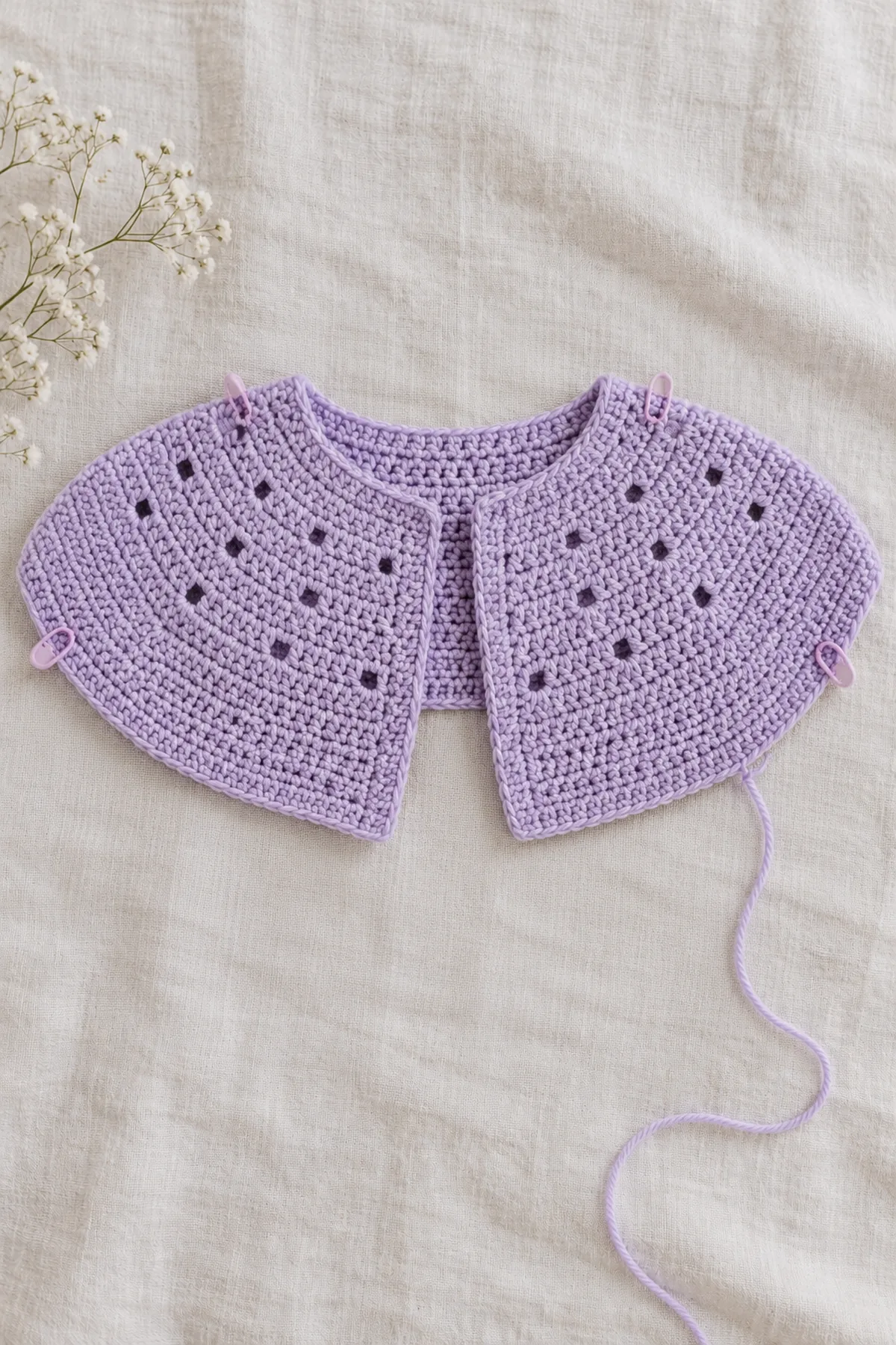 Unfinished lavender shallow oval crochet yoke with distributed shaping and sparse staggered tiny-eyelet rows, before sleeve separation
