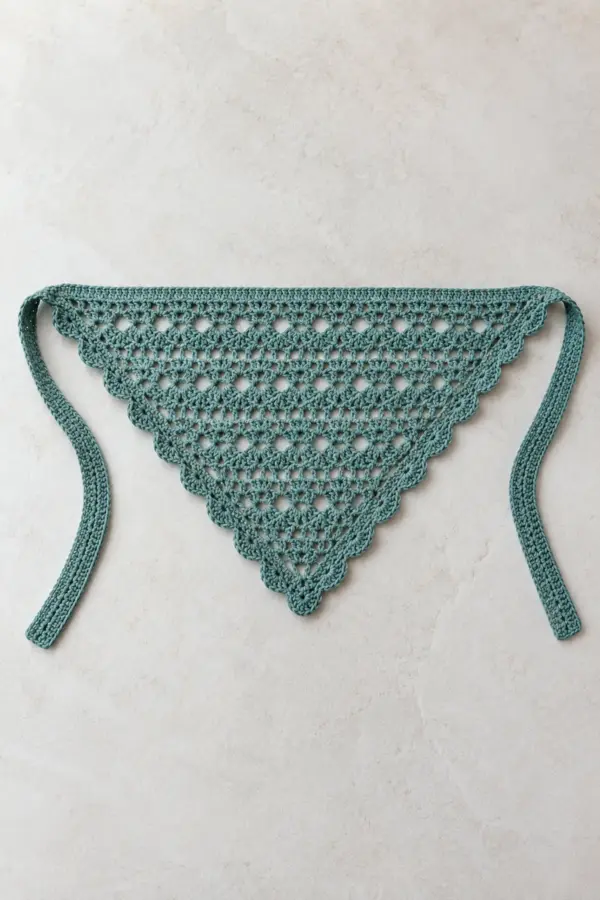 Original adult muted-teal crochet lace triangle hair bandana laid flat, shallow symmetrical triangle with alternating open V-stitch and eyelet rows, one continuous delicate scalloped border along both lower slopes and two wide flat corner ties, no motifs or beads